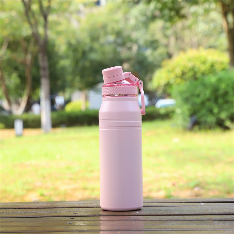 light pink vacuum insulated water bottle with carry handle