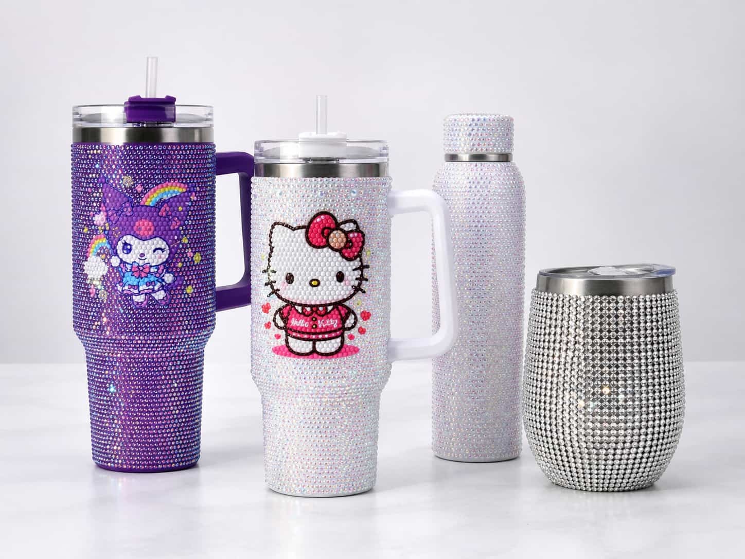 Rhinestone stainless steel tumbler and bottle collection with handled tumblers, straight bottle, and egg shape tumbler on a clean studio background