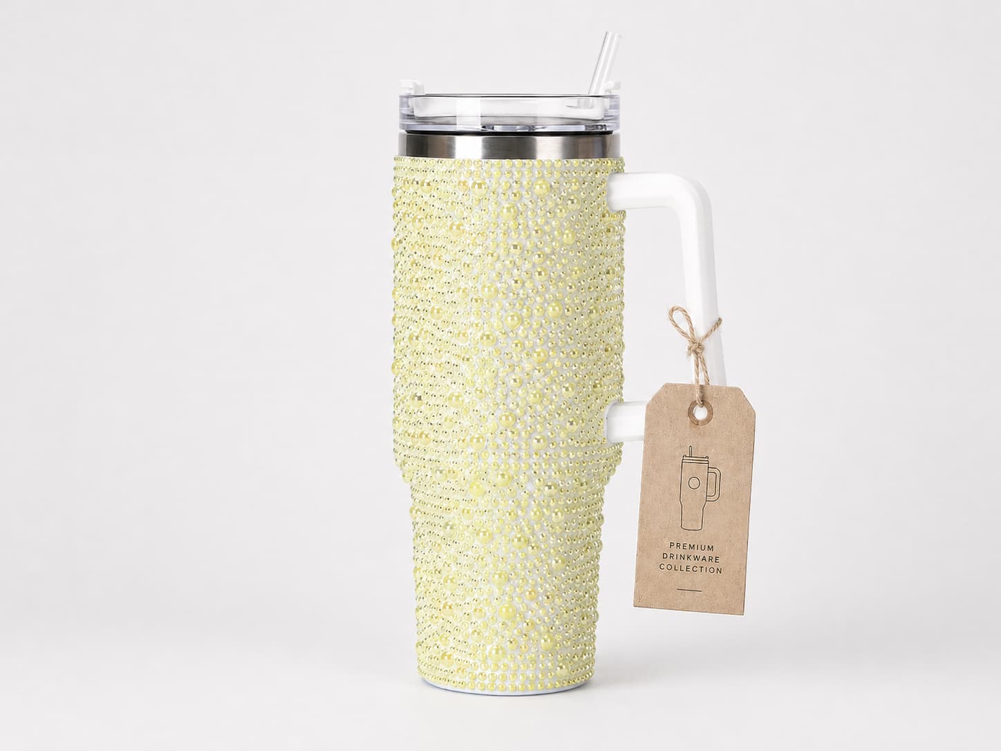 Yellow pearl rhinestone tumbler with handle and custom hang tag on a clean studio background