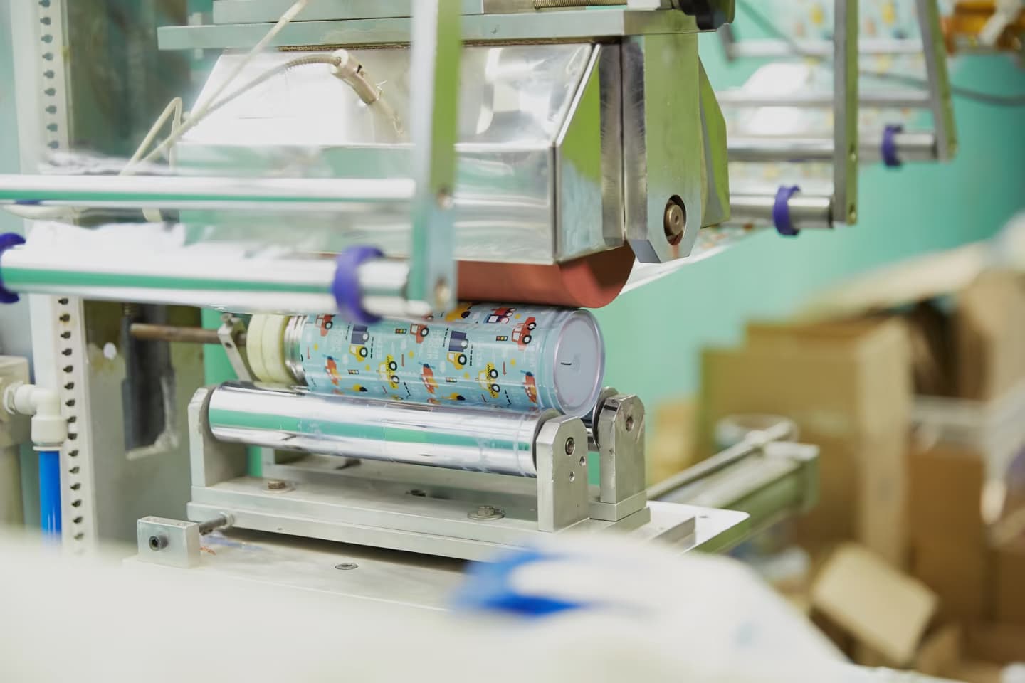 Sublimation printing machine transferring full-color artwork onto a coated stainless steel bottle