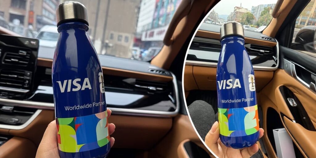 Custom blue 12oz cola-shaped insulated bottle with full-body 5D printing and gloss oil finish for a VISA World Cup event promotion and VIP gift project.